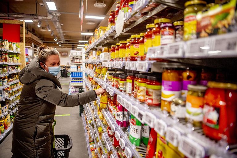 Een vrouw doet boodschappen. Op eerste kerstdag kan dat dit jaar bij de helft van de supermarkten in Nederland. - Foto: ANP